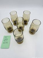 six Libbey amber footed glasses arranged in two rows