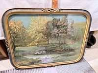 Full view of framed pond print leaning against surface