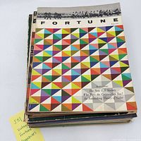 Stack of Fortune magazines, top shows geometric triangle cover