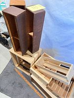Stacked view of eight wooden crates and boxes showing variety of sizes and finishes