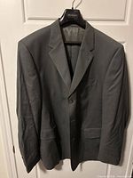 Front view of gray Barclays Premiato jacket on hanger