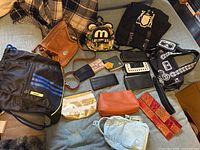 Group shot of all bags and wallets laid on sofa