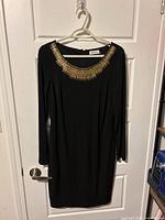 Full front view of black dress on hanger