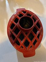Top view showing red lattice lid with central chimney