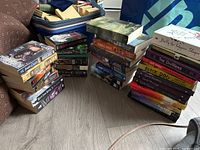 Overall view of three stacks of fantasy books showing quantity and variety