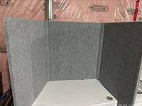 Grey tri-fold foam board standing partially opened