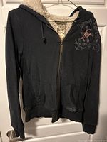 Front view of black sherpa-lined Groggy hoodie