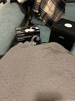 Blanket, Verbatim filter box, Sunbeam humidifier grouped on chair