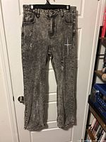 Full view of front of jeans showing overall style, color, and condition