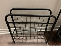 Front view of black metal magazine rack