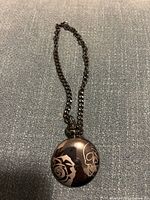 Front view showing full pocket watch with chain