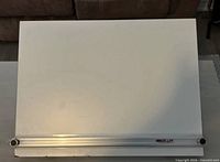 Top view of white drafting board with aluminium straightedge