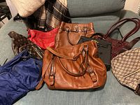 overview of eight handbags on couch