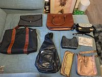 All nine purses arranged on sofa