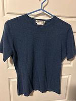 Front view of blue cashmere t-shirt on hanger