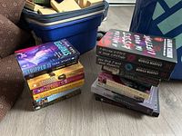 Two stacks of romance paperbacks showing titles and spines