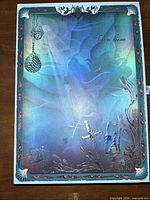 Front cover with holographic Ariel artwork and sea motifs