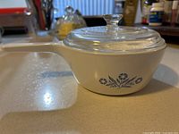 Side view of Corning Ware saucepan with Cornflower motif and Pyrex lid