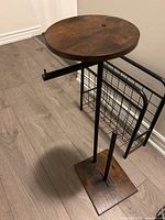 Full view of stand showing wood shelf, metal frame, and base