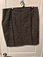 Front view of brown herringbone wool skirt hanging