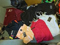 Overall view of all workout clothing and shapewear laid out on sofa