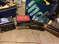All books grouped on floor in three stacks