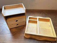 Bamboo organizer next to pine tray, top view