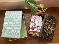 two decorative storage boxes, one opened showing assorted crafting materials