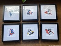 All six framed goalie mask prints displayed together