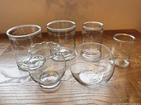 Group shot of all six clear glass vases