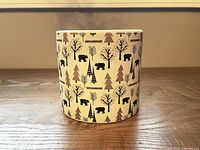 Front view of cylindrical ceramic planter showing bear and tree pattern