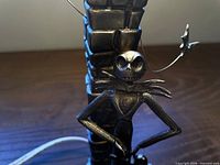 Close-up of Jack Skellington figure on pewter lamp