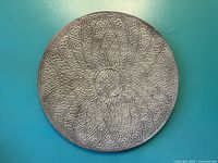 Full view of round metal wall decor on wall