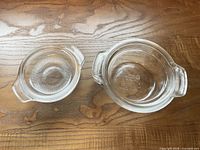 Pair of clear glass casserole dishes and lids top view