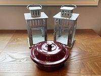 Pampered Chef round baker with lid and two galvanized lanterns