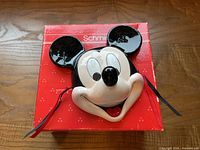 Front view of ceramic Mickey Mouse mask on box