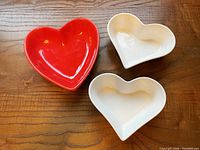 Top view showing red and two white heart-shaped dishes