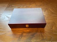 Closed mahogany box showing lid scratches