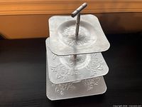 Front angled view of three-tier embossed aluminum stand