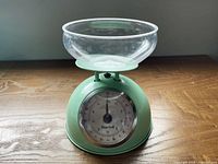 Front view of mint green Starfrit kitchen scale with clear bowl
