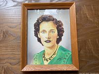 Frontal view of signed watercolour portrait in wood frame