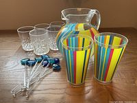 Full lot: striped pitcher, two tall tumblers, six faceted tumblers, swizzle sticks