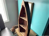 Front view of wooden boat shelf showing three shelves