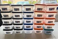 Front view of stacked Sterilite containers showing lid colours and labels