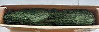 Boxed unassembled green artificial Christmas tree sections
