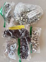 Overall lot showing six sealed bags of assorted 3/8-16 hardware