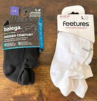 Front view of both sock packages showing brands, styles, sizes