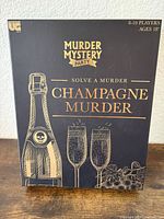 Front of sealed Champagne Murder Mystery Party game box