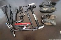 Overview of lot: shoes, handlebars, saddles, derailleurs, pump