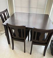 Dining table with three matching chairs